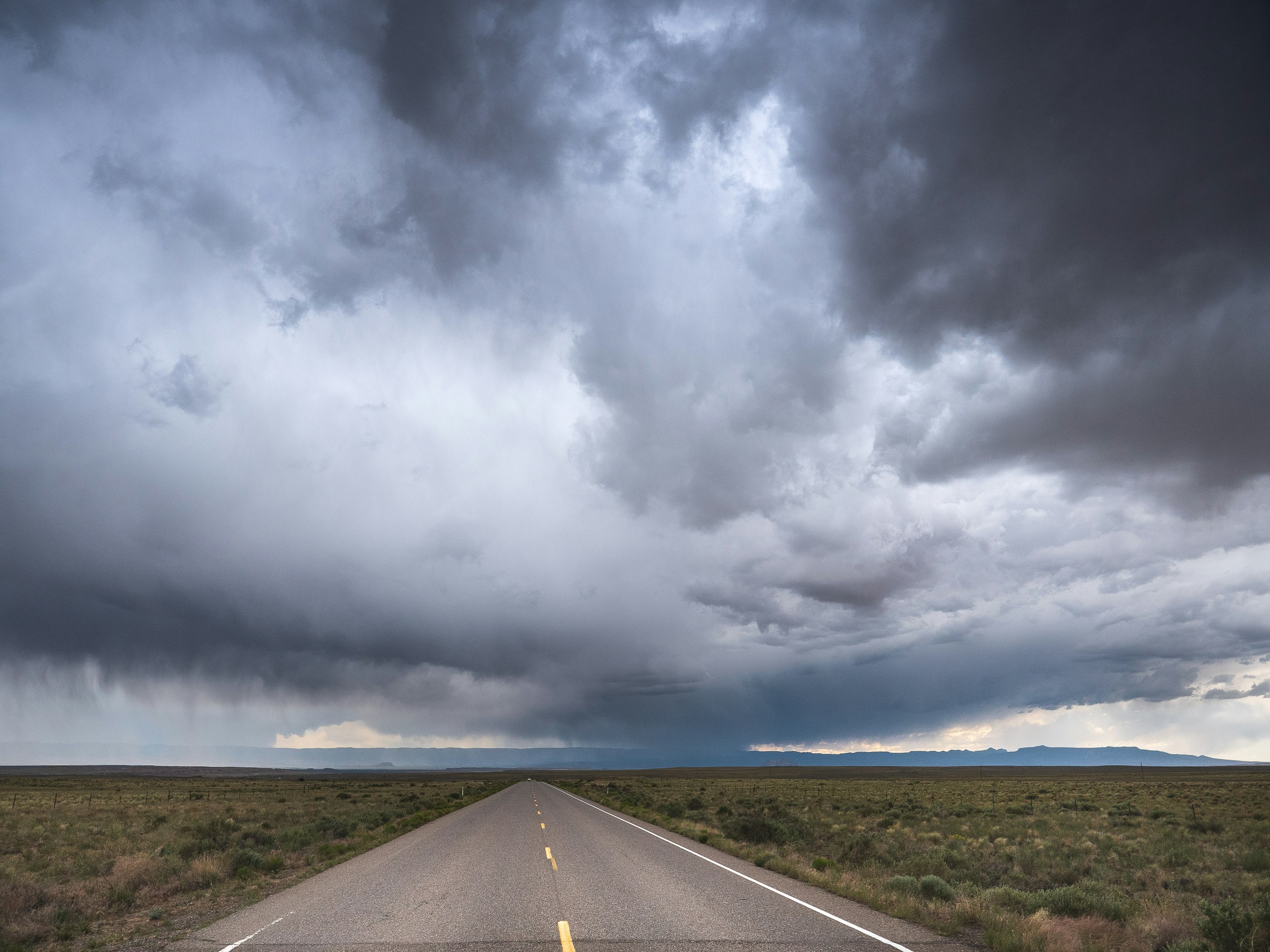 gray asphalt road under gray clouds